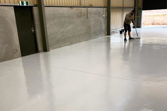 Member of Complete Coatings Company is in the process of concrete sealing